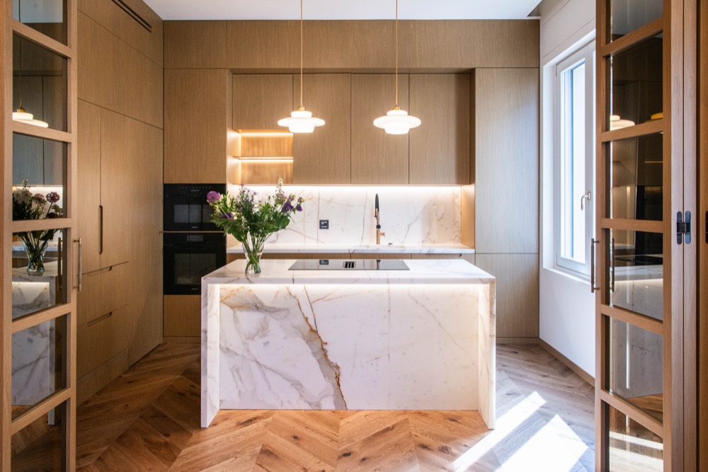 Kitchen in daylight, with a Miele oven and the dining room beyond